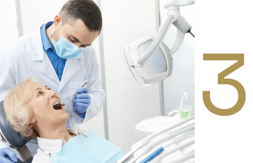 Dentist examining senior patient during dental consultation at Advanced Implant & Cosmetic Dentistry, emphasizing personalized care and comfort in dental implant procedures.