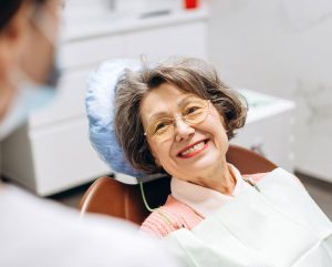Older patient smiling at our NYC dental office